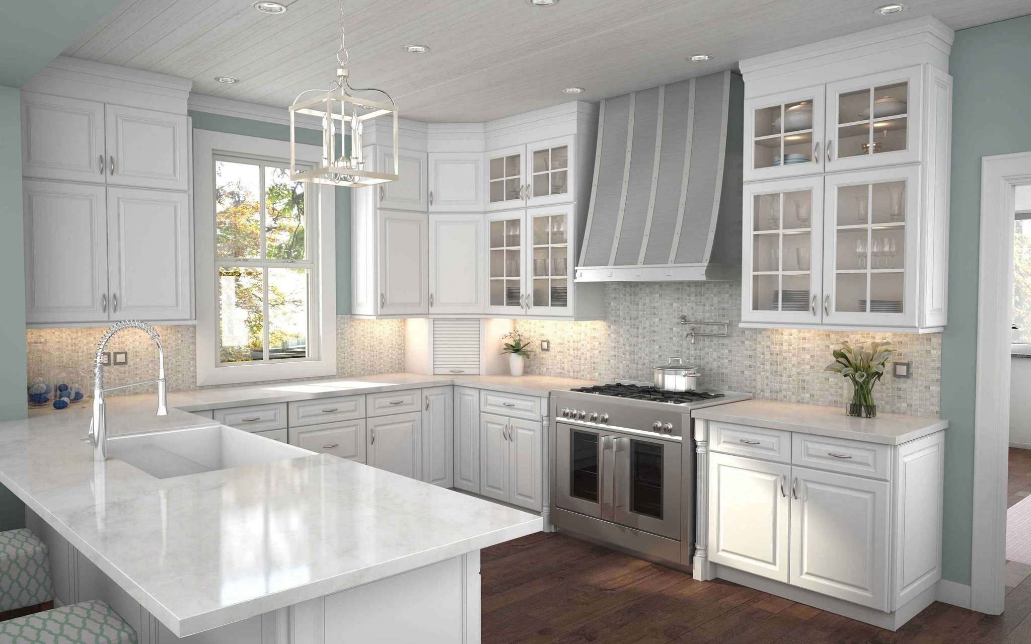 Modern white kitchen with stainless steel appliances.