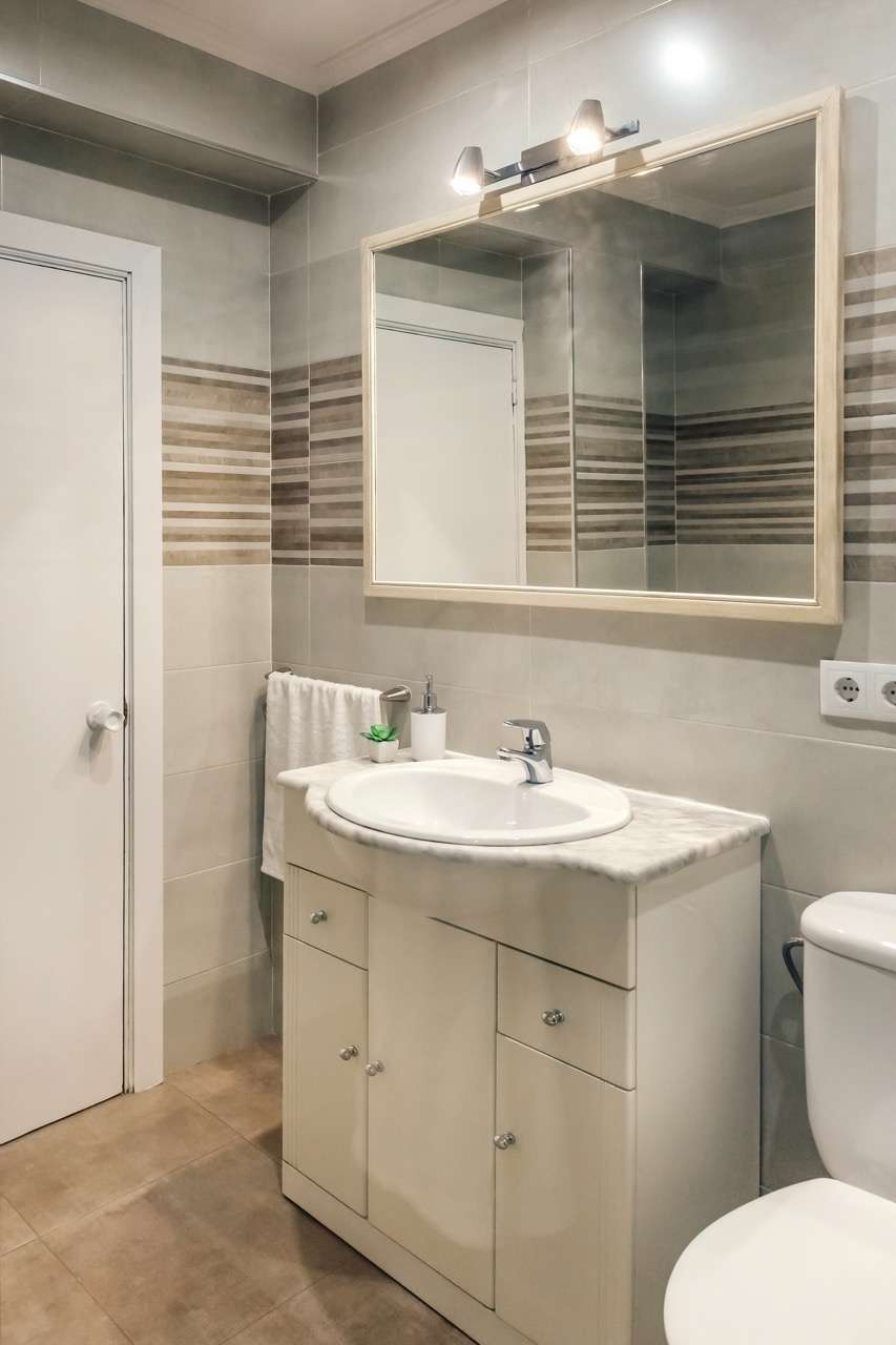 Modern bathroom with mirror, sink, and cabinet