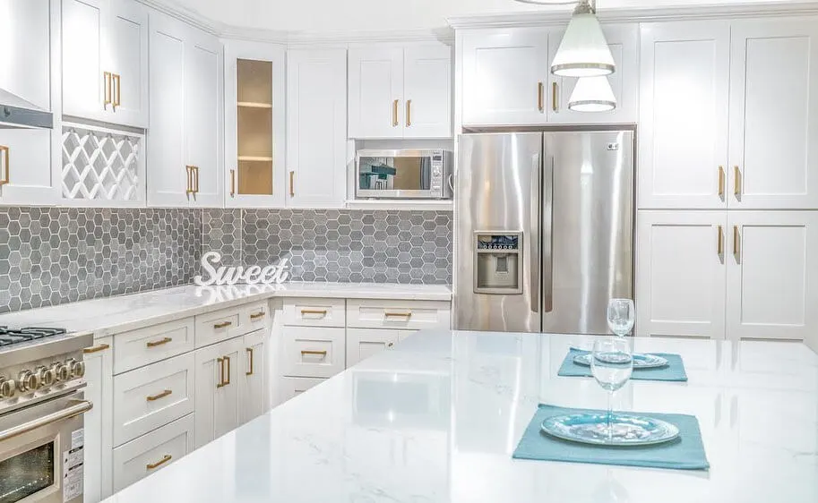 Modern white kitchen with stainless steel appliances